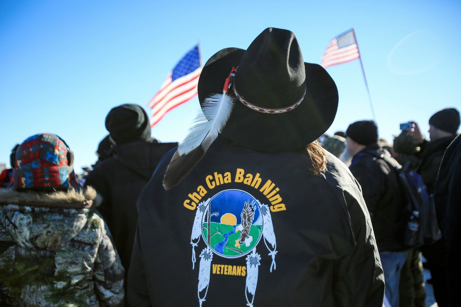 A man stands among veterans
